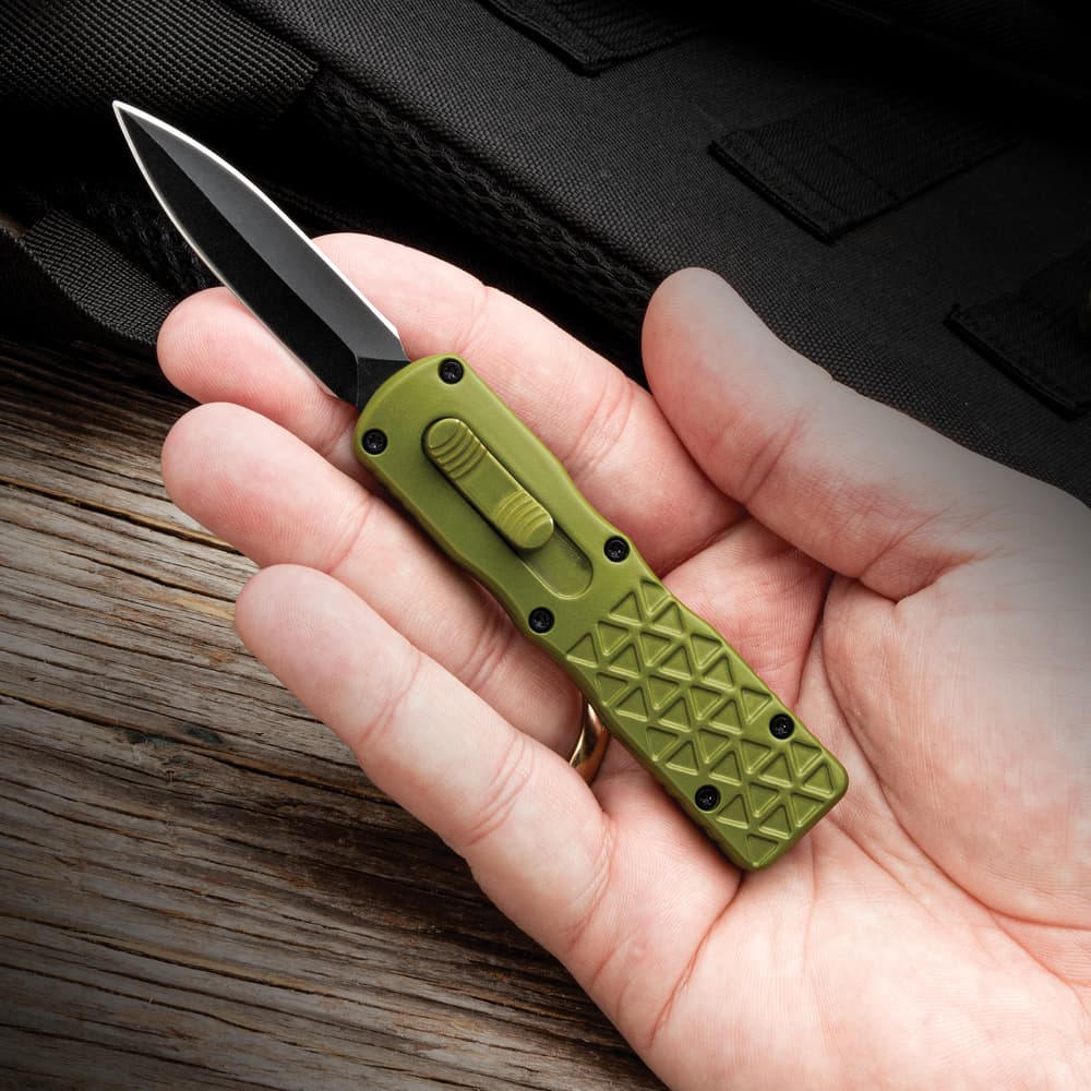 Full image of the Mini Jade Striker OTF opened and held in hand. image number 3