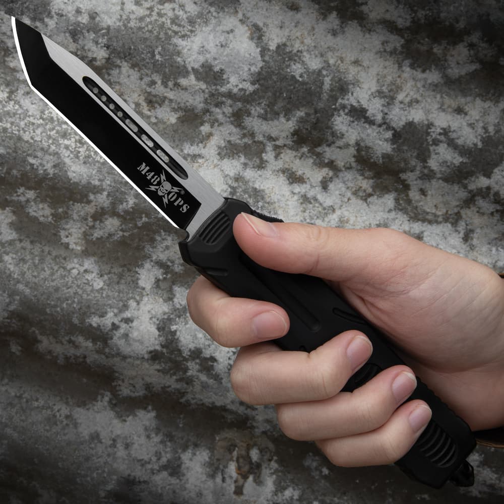 Closed OTF Tanto pocket knife featuring a glass breaking pommel and a raised "M48" logo along with a detailed handle with stylish engravings. image number 3