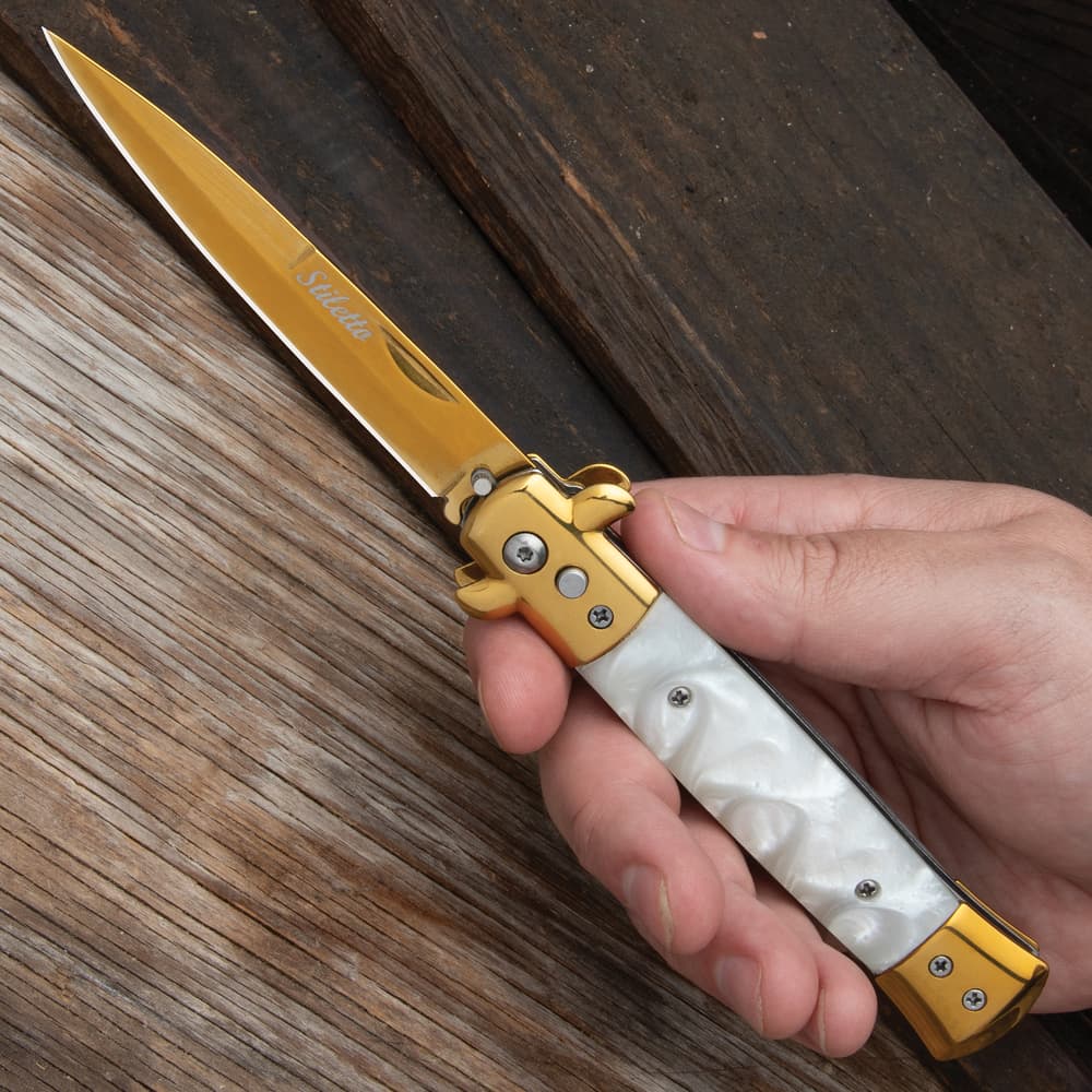 The Gold Stiletto Auto Knife in hand image number 3