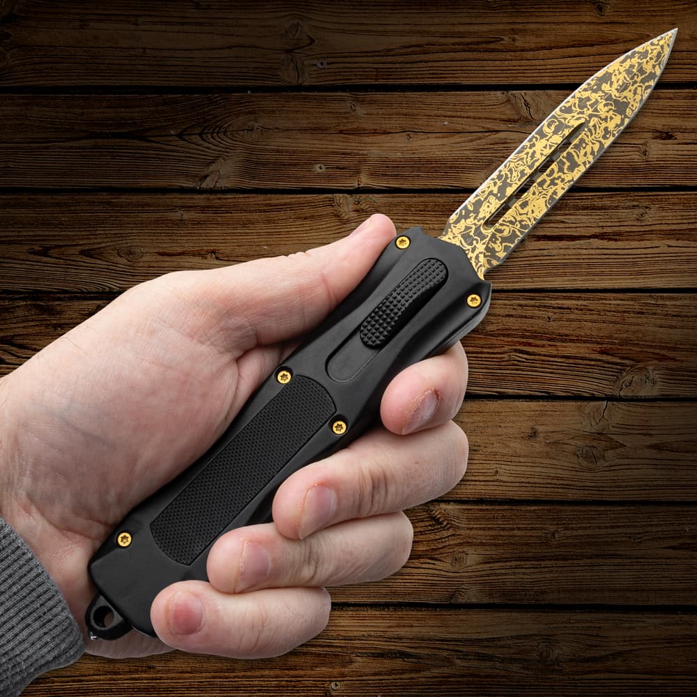 Full image of the OTF Knife open being held in hand. image number 3