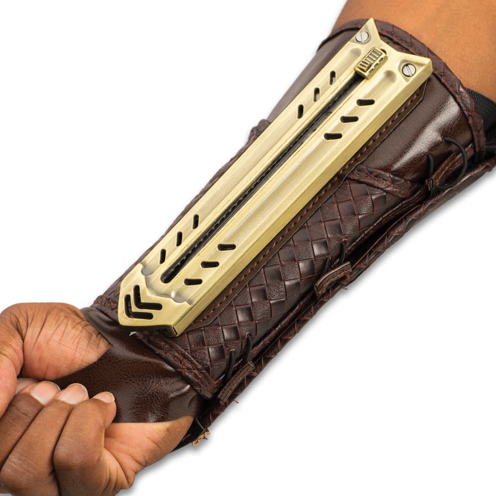 Retracted tactical gauntlet compossed of mahogany brown faux leather and gold blade enclosure attached to the inner forearm. image number 3