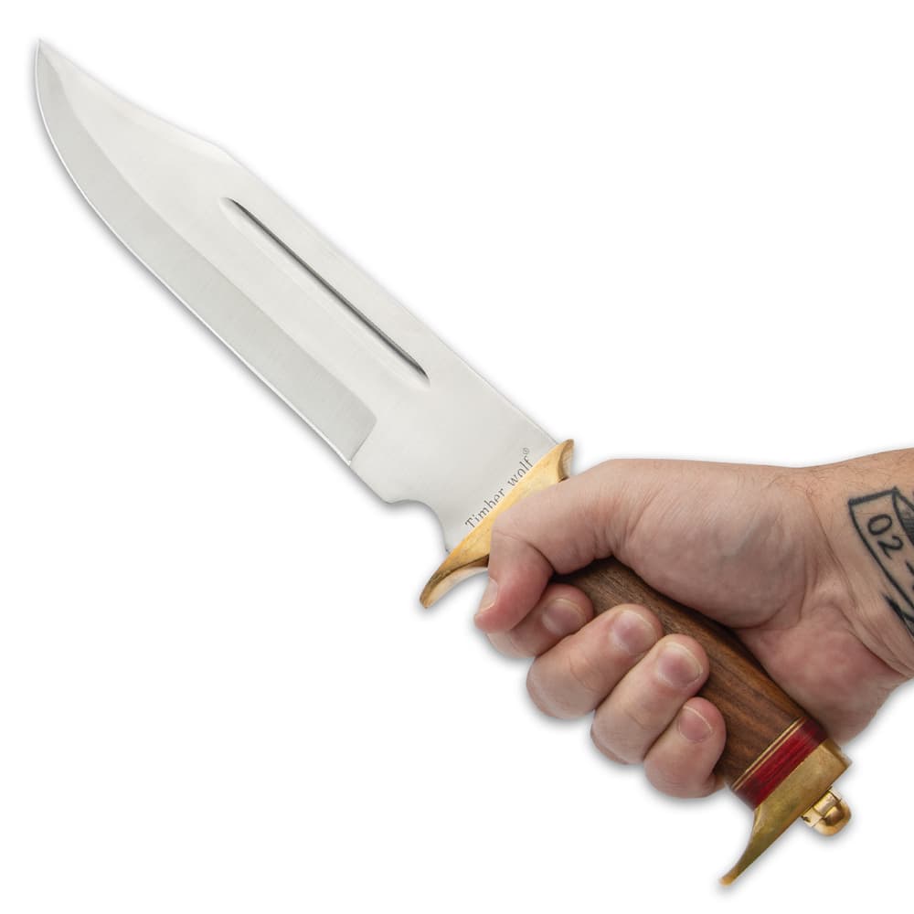 The knife has a razor-sharp 11 1/2” stainless steel, clip point blade, extending from a hefty, polished brass half-guard image number 3