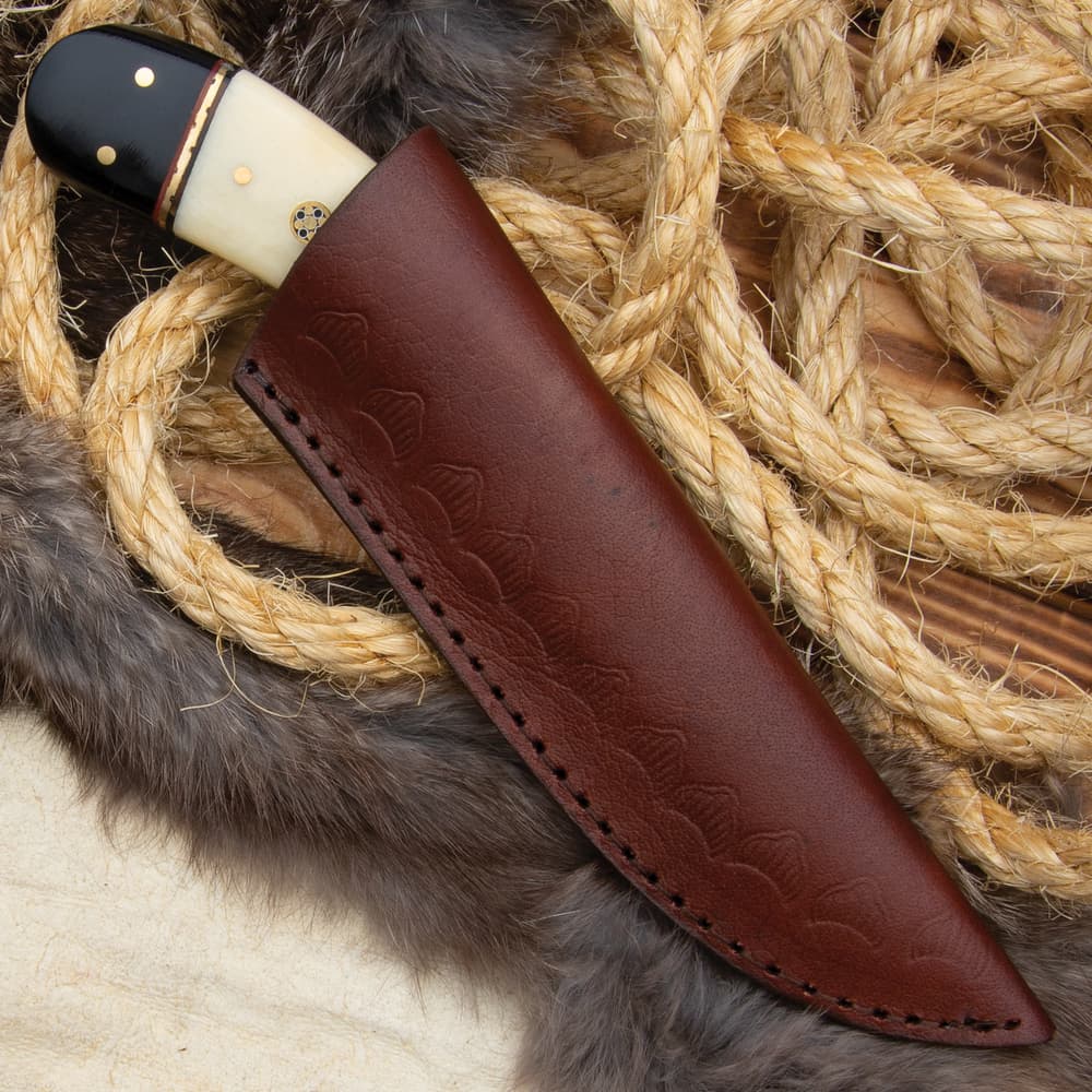 The 7 3/4” overall fixed blade knife can be carried and stored in a premium leather belt sheath image number 3