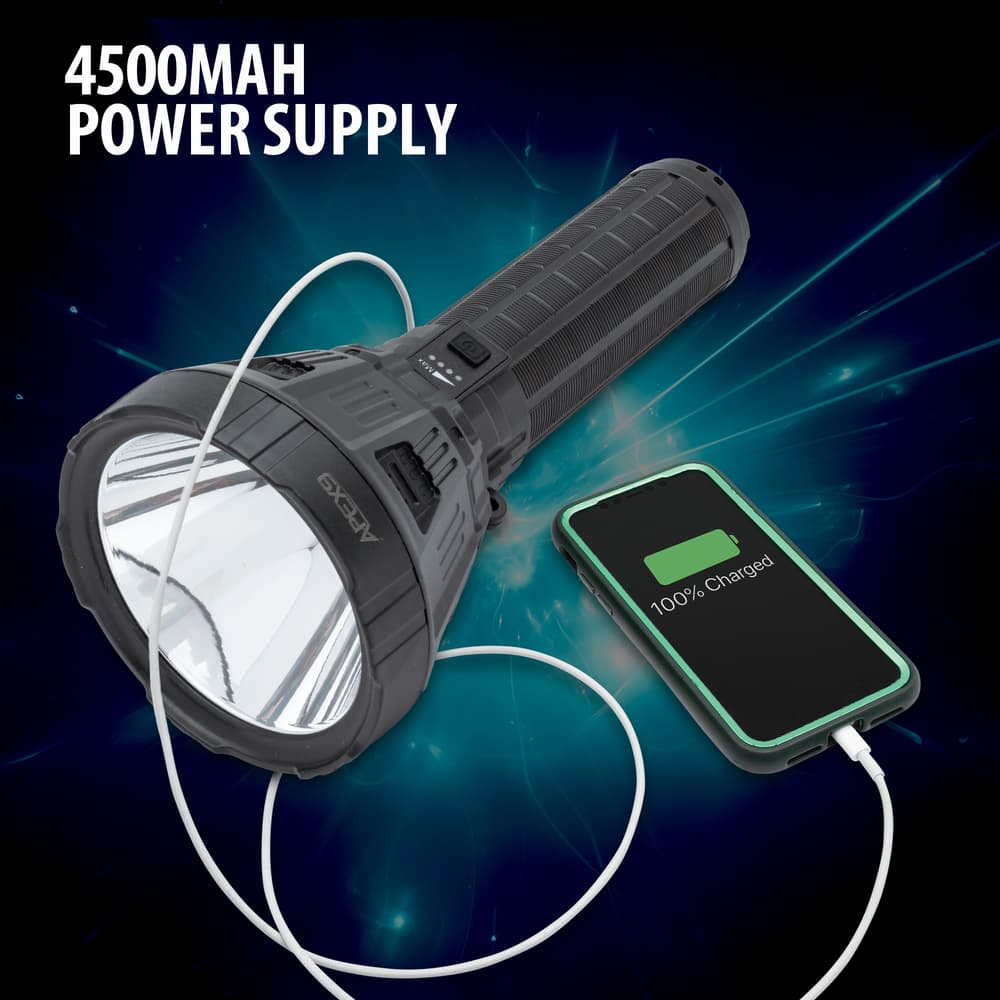 Full image of the LED Spotlight Flashlight charging a cell phone with its 4500 mAh power supply. image number 3