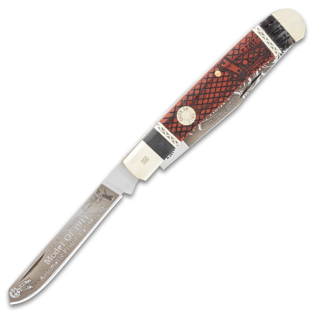 The pocket knife has a spey blade with a nail nick and laser-etched artwork. image number 3
