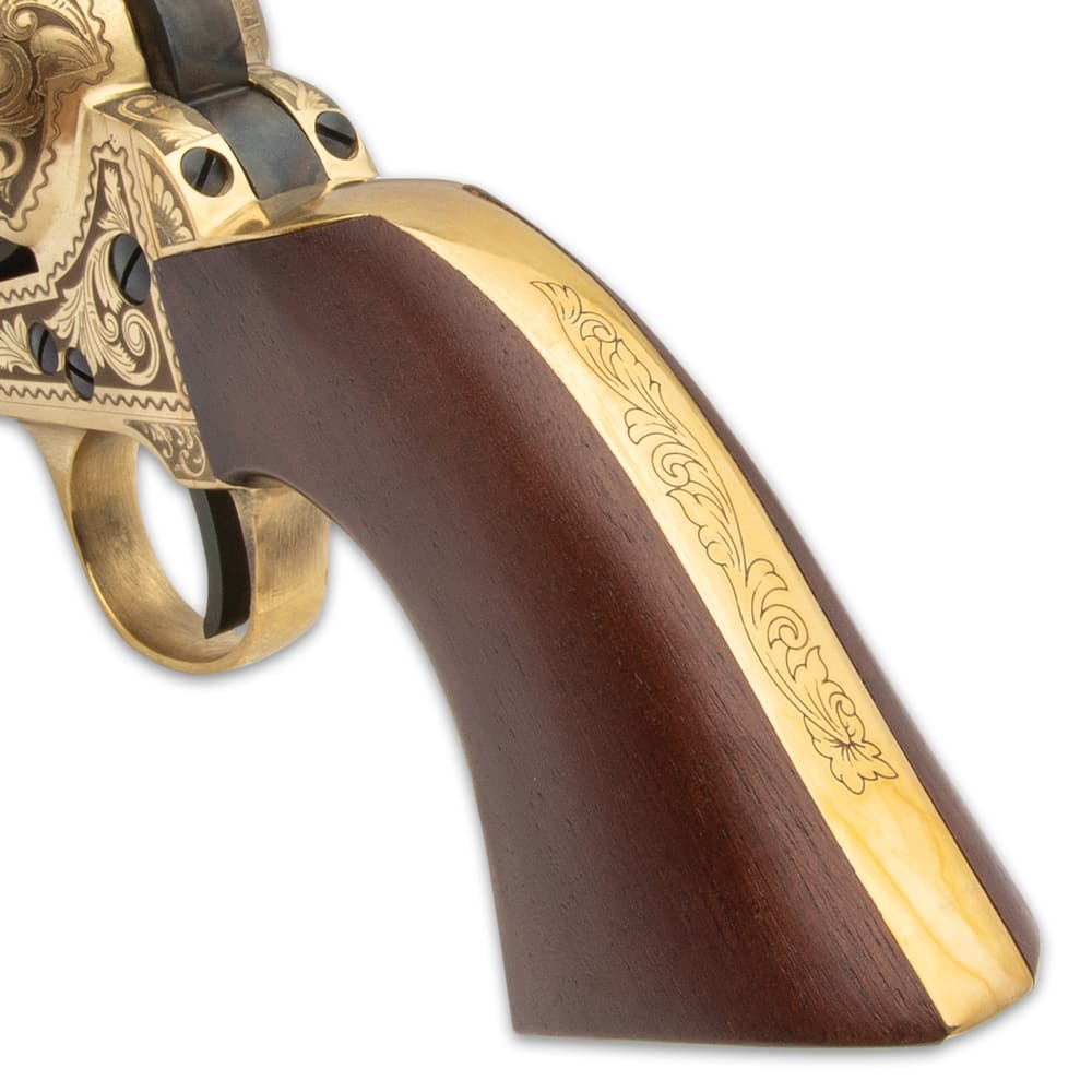 The .44 caliber, black powder pistol has an engraved solid brass frame with a 7 1/2” blued barrel and a wooden grip image number 3