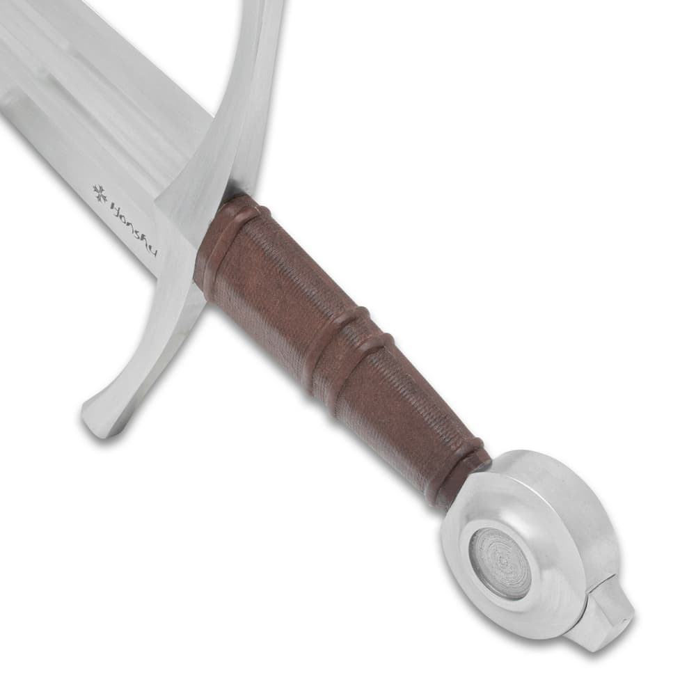 Angled view of the Double Fuller Sword’s brown leather wrapped grip and circular pommel. image number 3