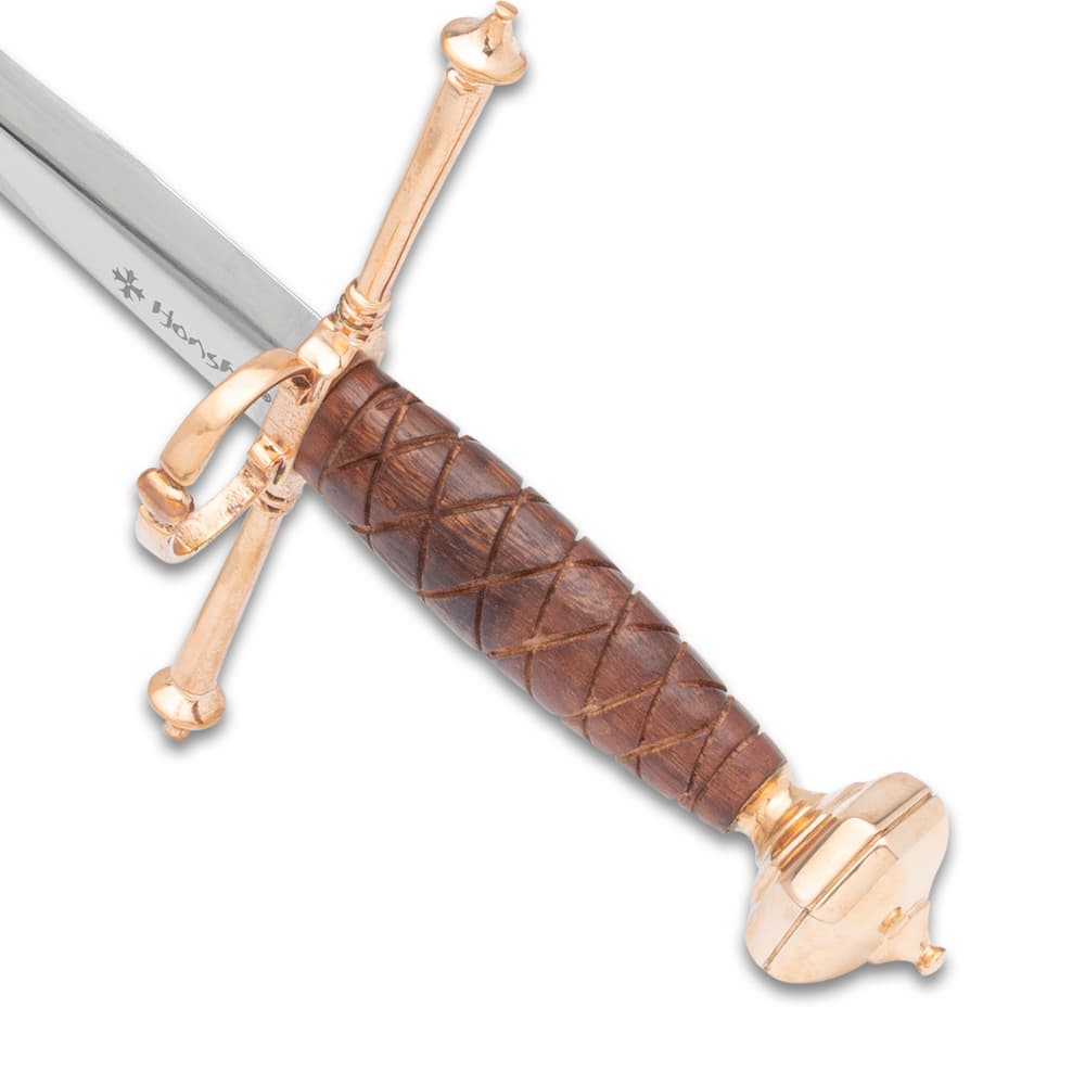 A detailed look at the crosshatching on the Honshu Italian Dagger’s wooden handle with gold-colored rounded pommel and crossguard with ring. image number 3