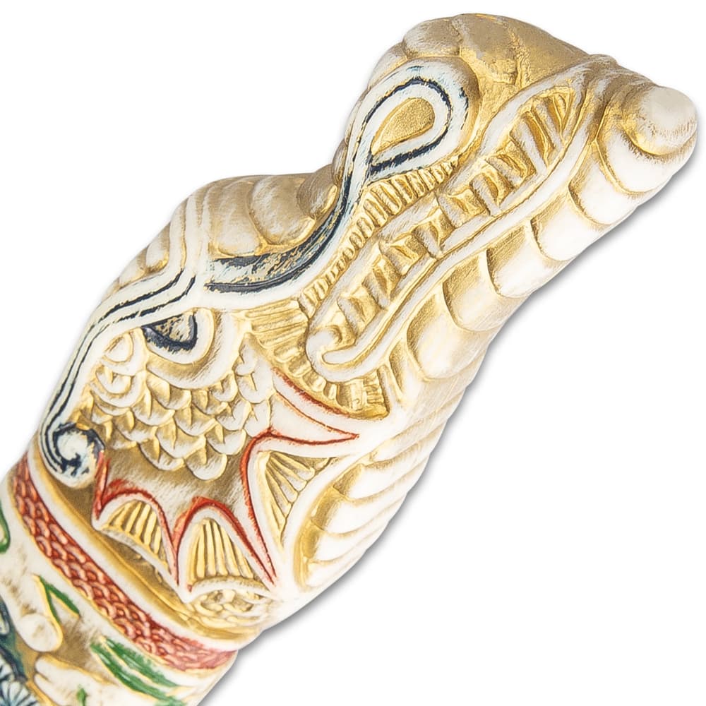 The pommel has a dragon carved into the faux ivory. image number 3