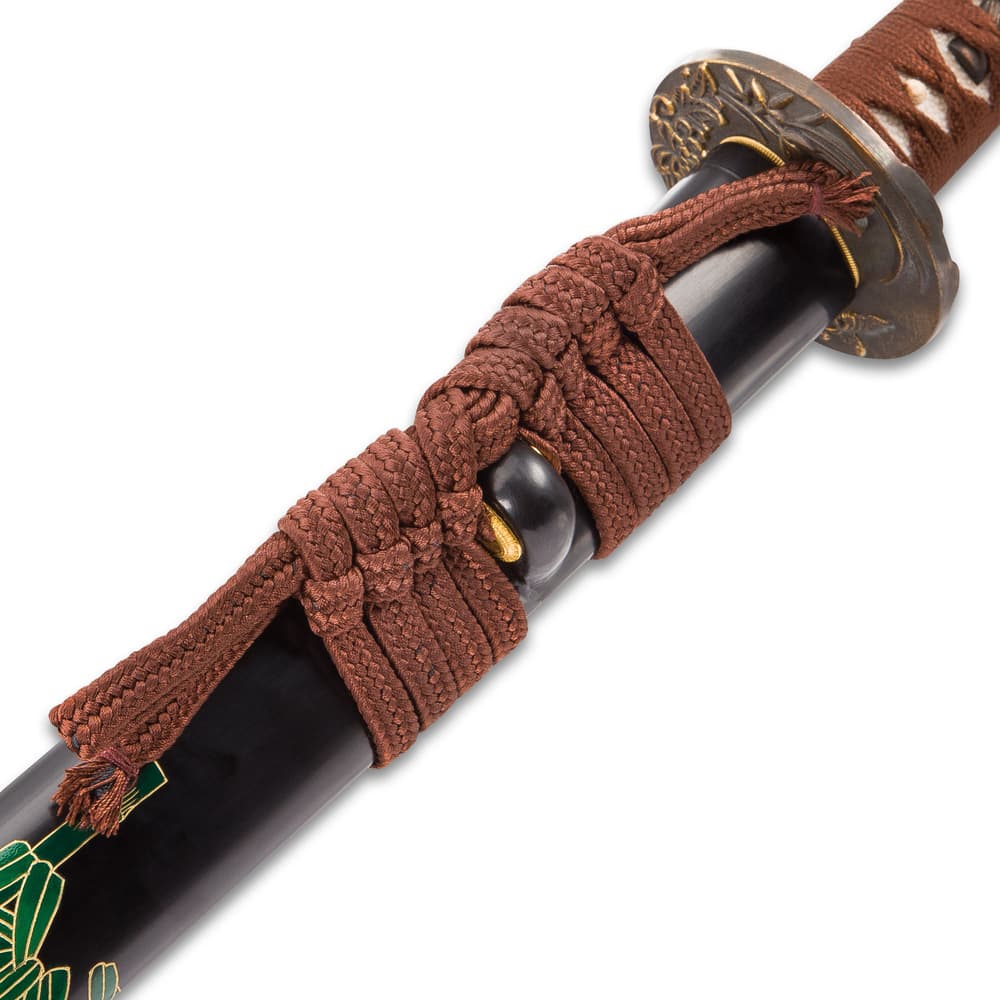 The scabbard has a braided brown hanging cord wrapped around it. image number 3