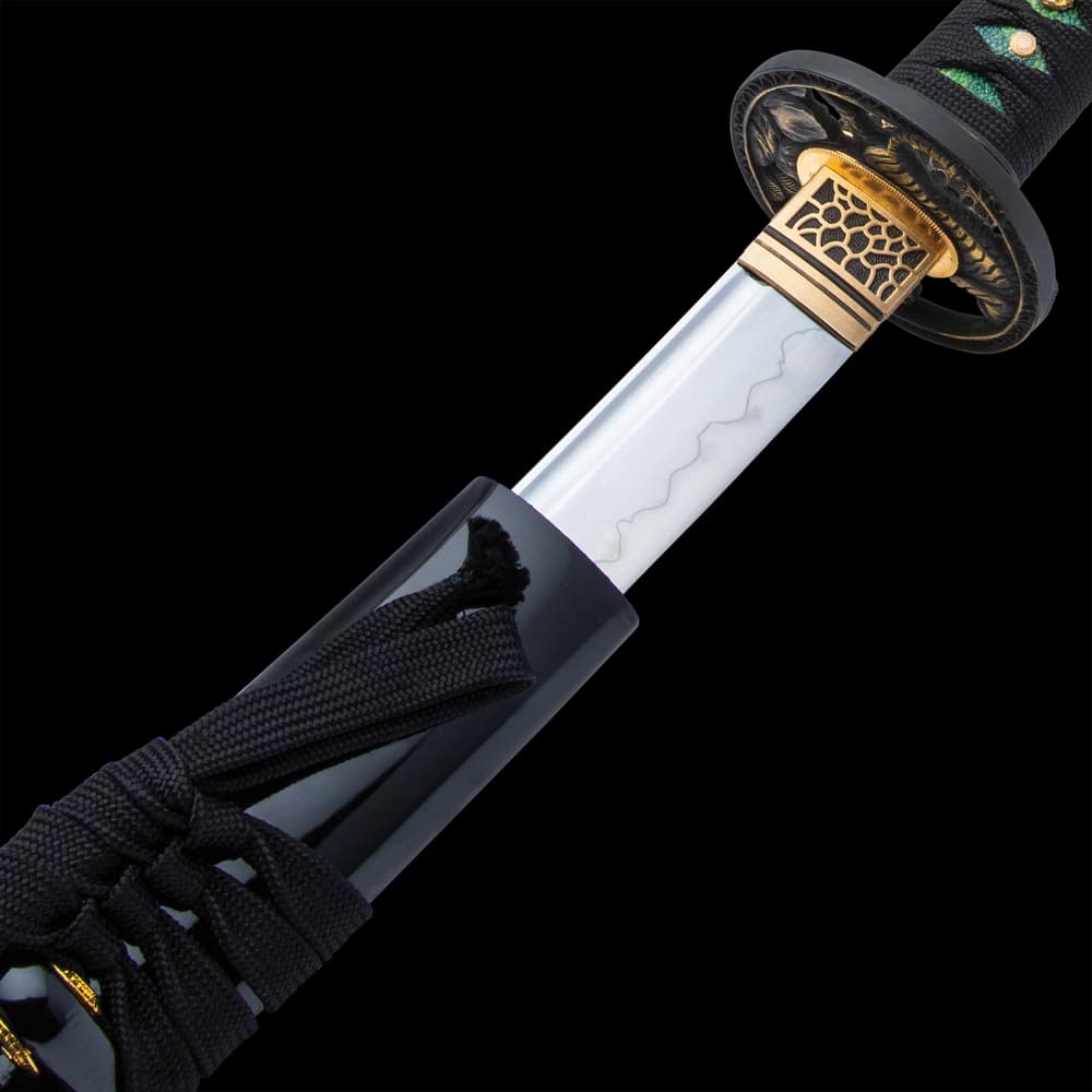 The 40” overall katana slides smoothly into a black, lacquered scabbard, accented with black cord-wrap to match the handle image number 3
