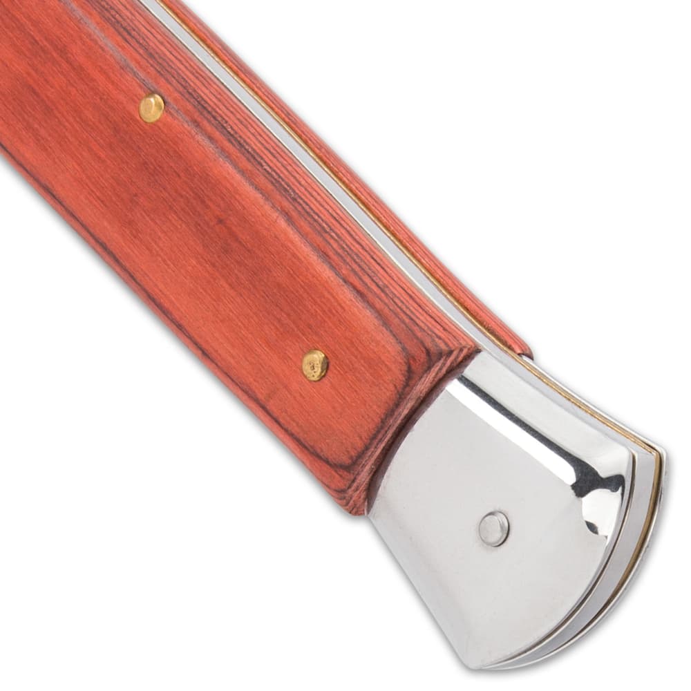 Upclose view of mahogany colored wooden handle and mirror-polished end. image number 4