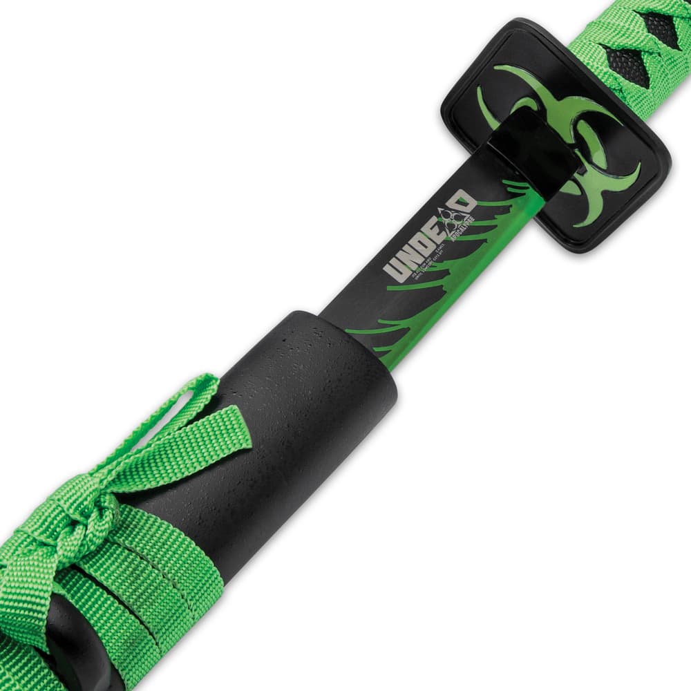 The sword has a sharp, 27” carbon steel blade with a black finish with green silk painting and “Zombie Hunter” in white image number 4