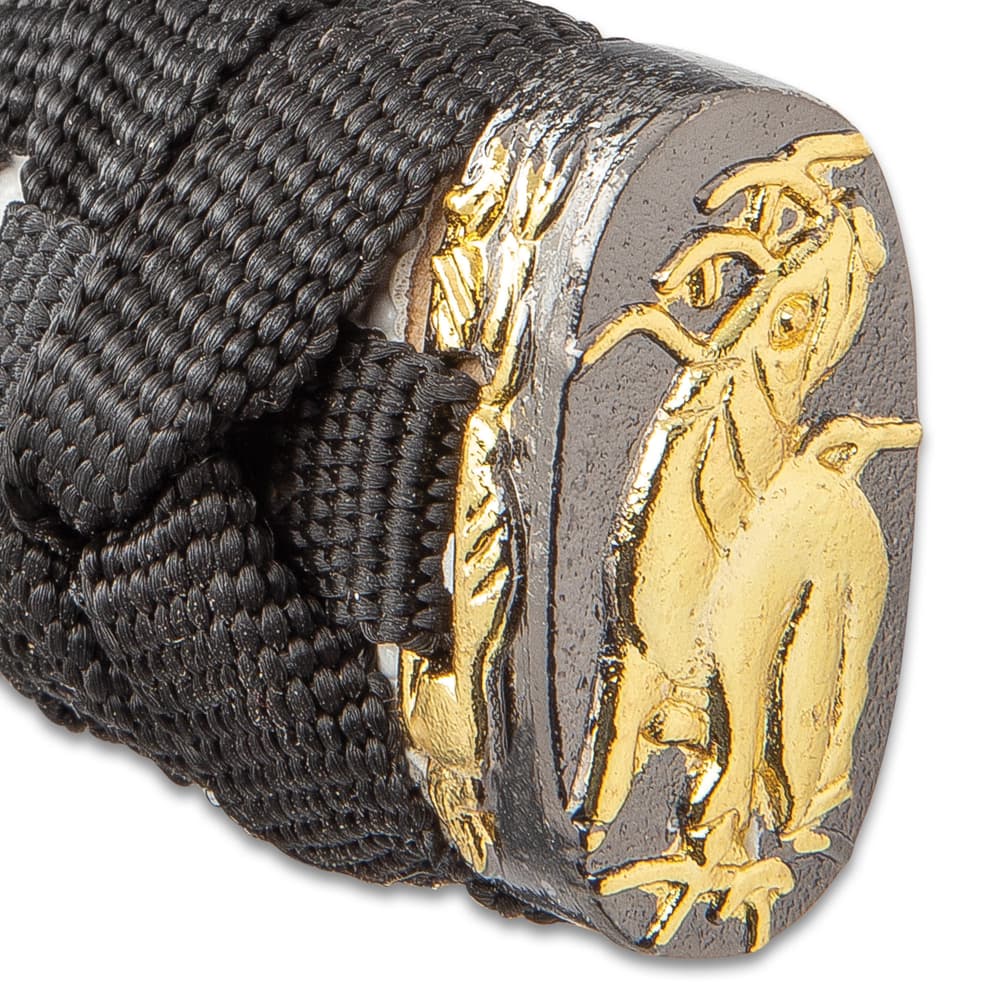 The pommel is detailed with a gold color design just above the black cord wrapped handle. image number 4