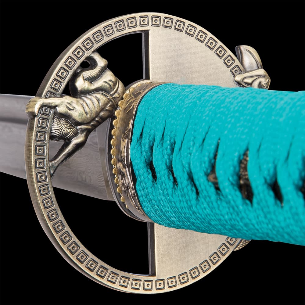 Zoomed view of the cast metal tsuba and teal cord wrapping the handle. image number 4