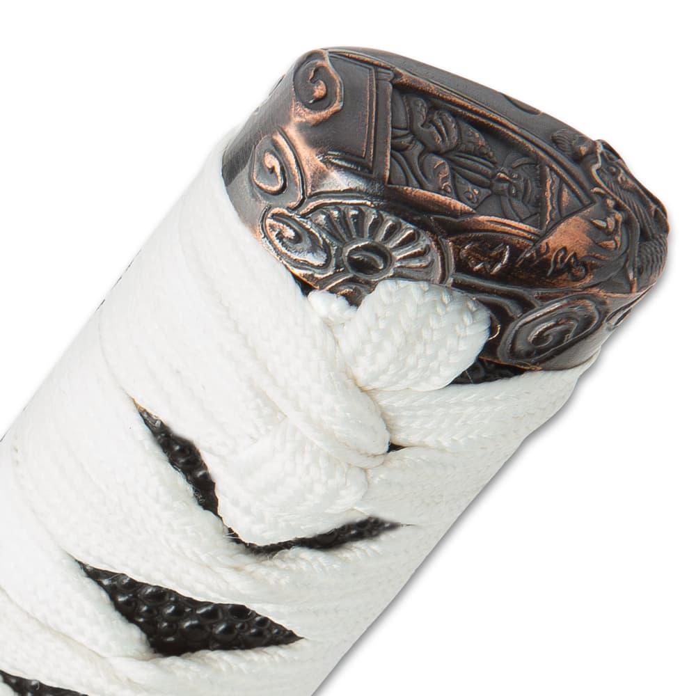 The white braided cord wrapping the handle runs through the ornate brass pommel. image number 4