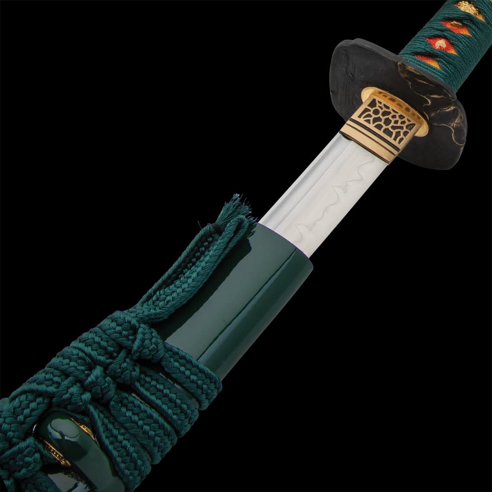 The 40” overall katana slides smoothly into a black, lacquered scabbard, accented with teal cord-wrap to match the handle image number 4