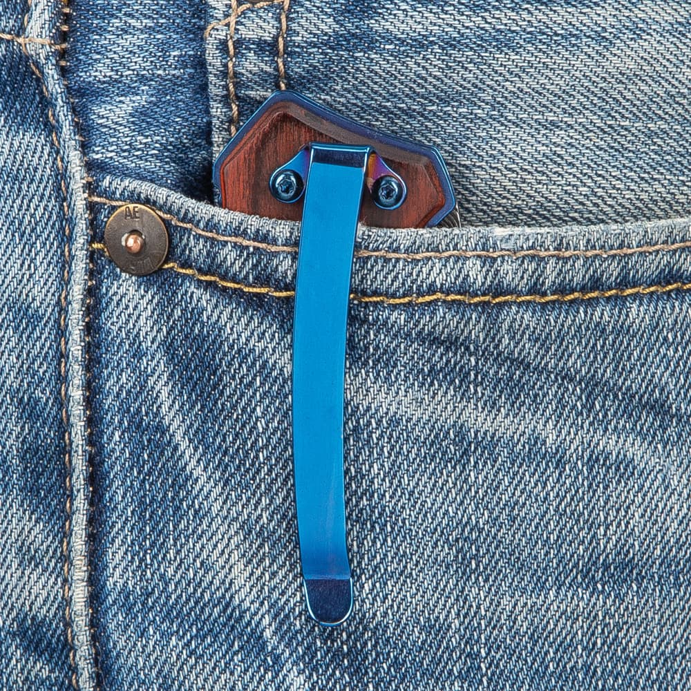 The knife is shown clipped into a denim pocket with the metallic blue pocket clip showing. image number 5
