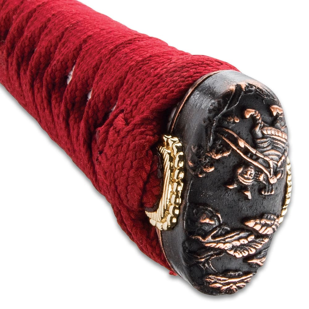 The hardwood handle is traditionally wrapped in faux rayskin and red cord and has an intricately detailed metal tsuba image number 5