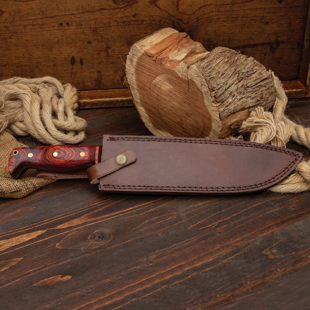 The Heart of Darkness Bowie Knife shown in its leather sheath image number 6