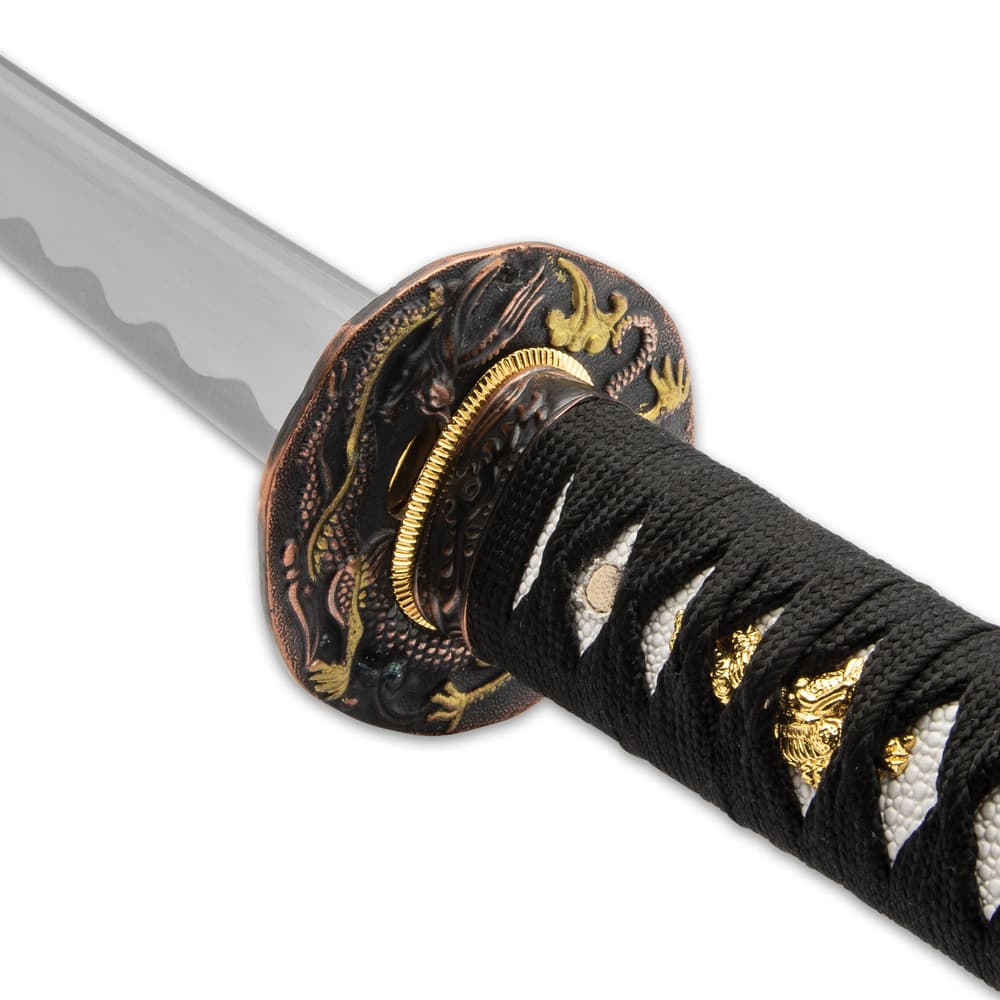 The hardwood handle is wrapped in faux rayskin and black cord and has an intricately detailed metal alloy tsuba image number 6