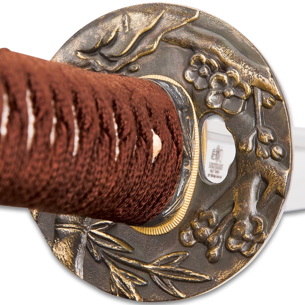 Zoomed view of the cast tsuba with floral and bamboo pattern. image number 6