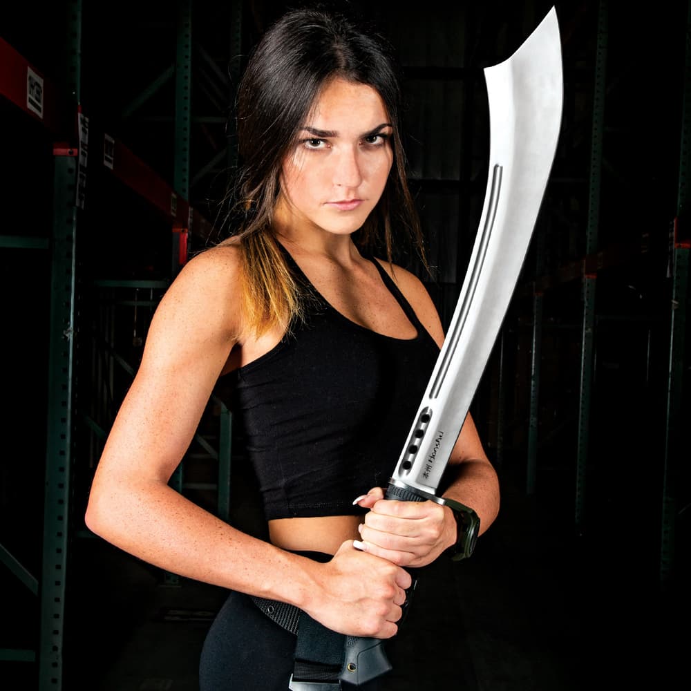 Woman dressed in black posed holding large stainless steel sword with sharp pointed tip image number 7