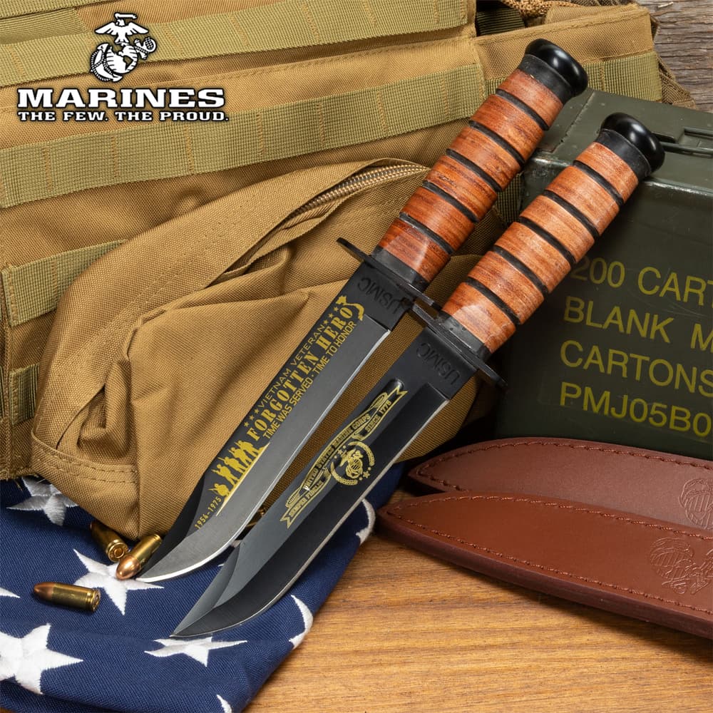 Three USMC knives with engraved blades on a flag background image number 0
