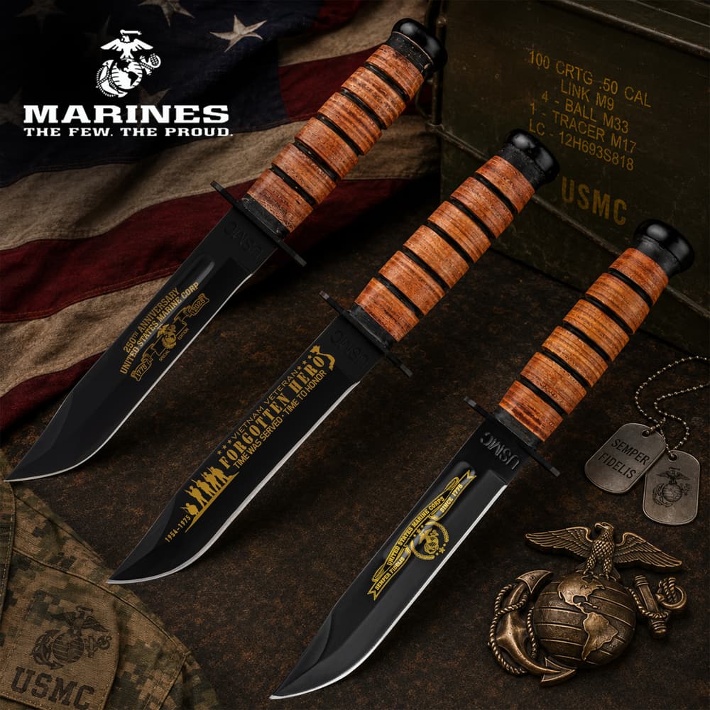 Three USMC knives with engraved blades on a flag background image number 0