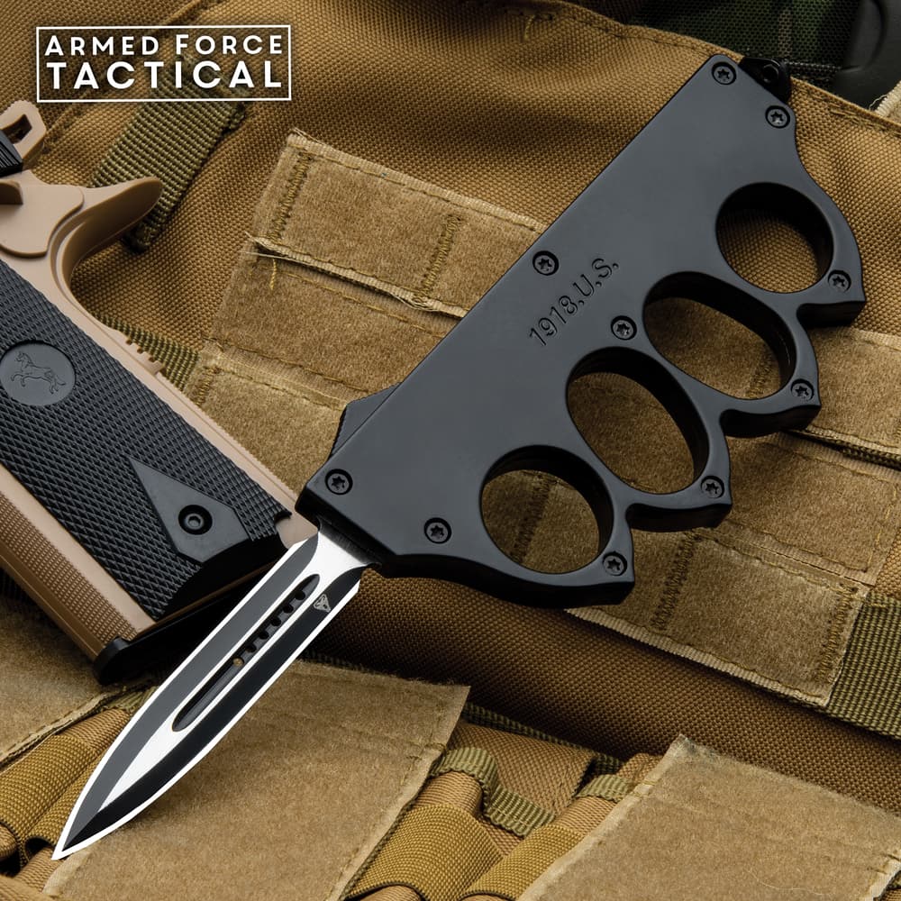 Tactical knife with knuckle grip on military gear image number 0