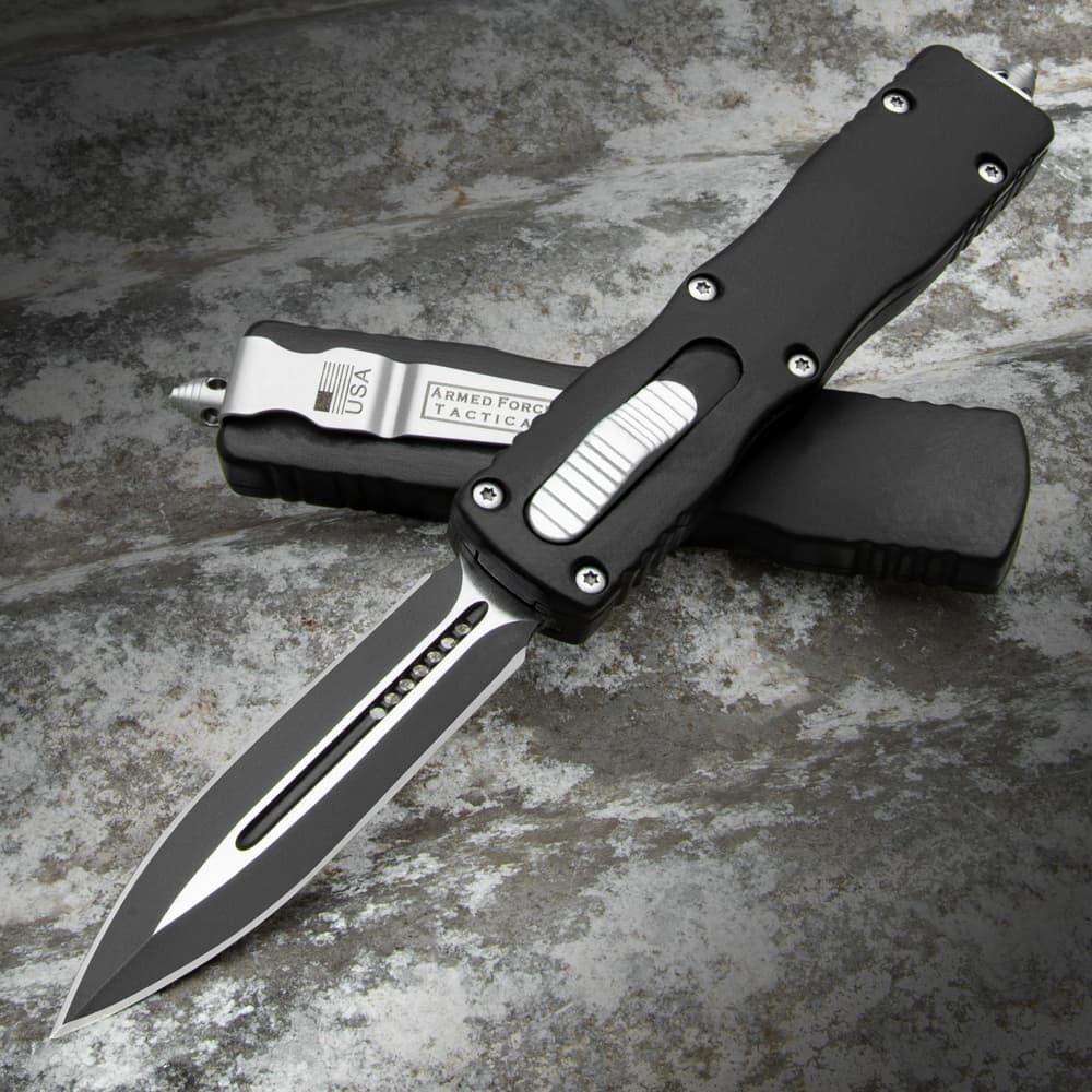 The Black Dagger OTF Knife with black handle and black stainless steel blade, shown both opened and closed. image number 0