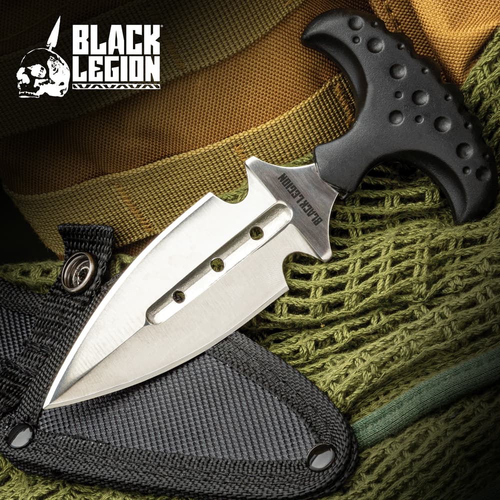 The black legion push dagger and sheath laying on green netting image number 0