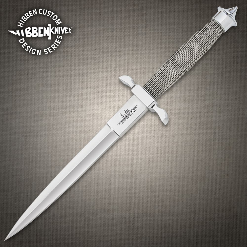 Satin finish dagger knife with a wire wrapped hilt and hefty handguard inscribed with "Gil Hibben" on a background of black stone. image number 0