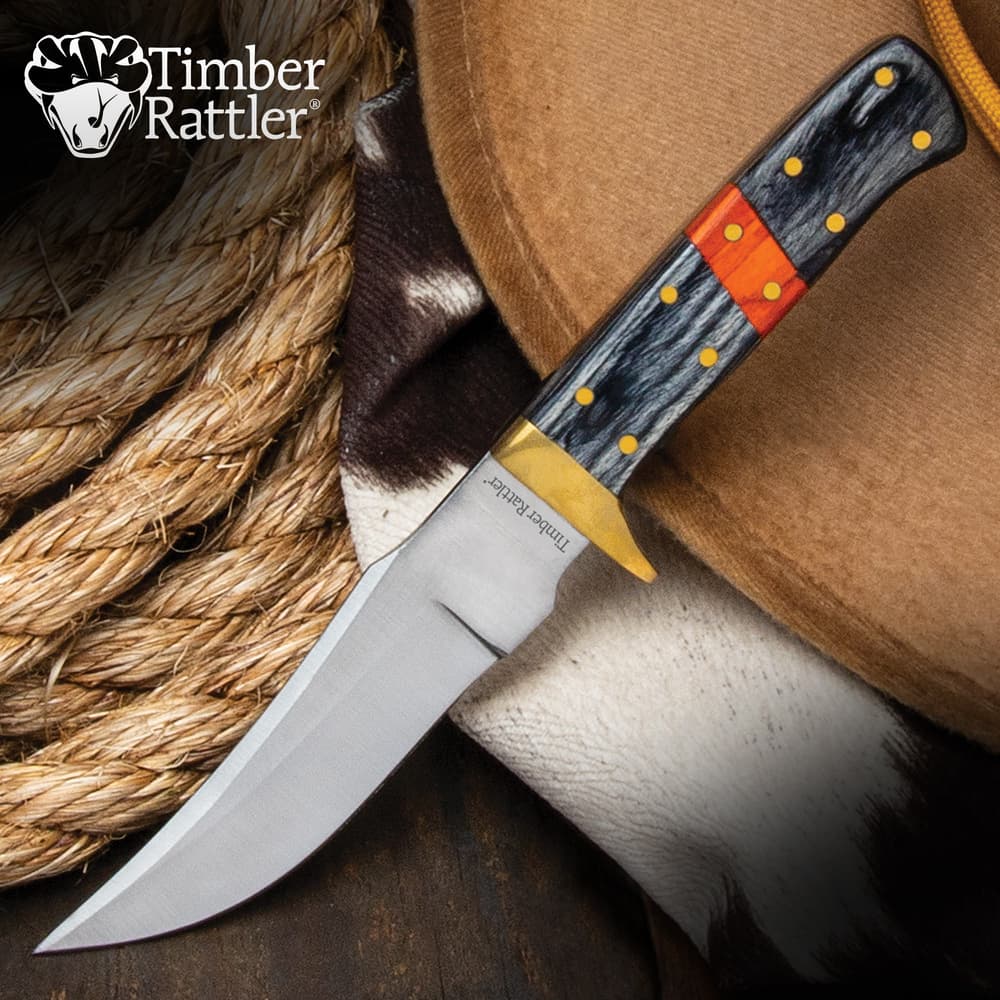 Knife with black and orange handle on a cowboy hat image number 0