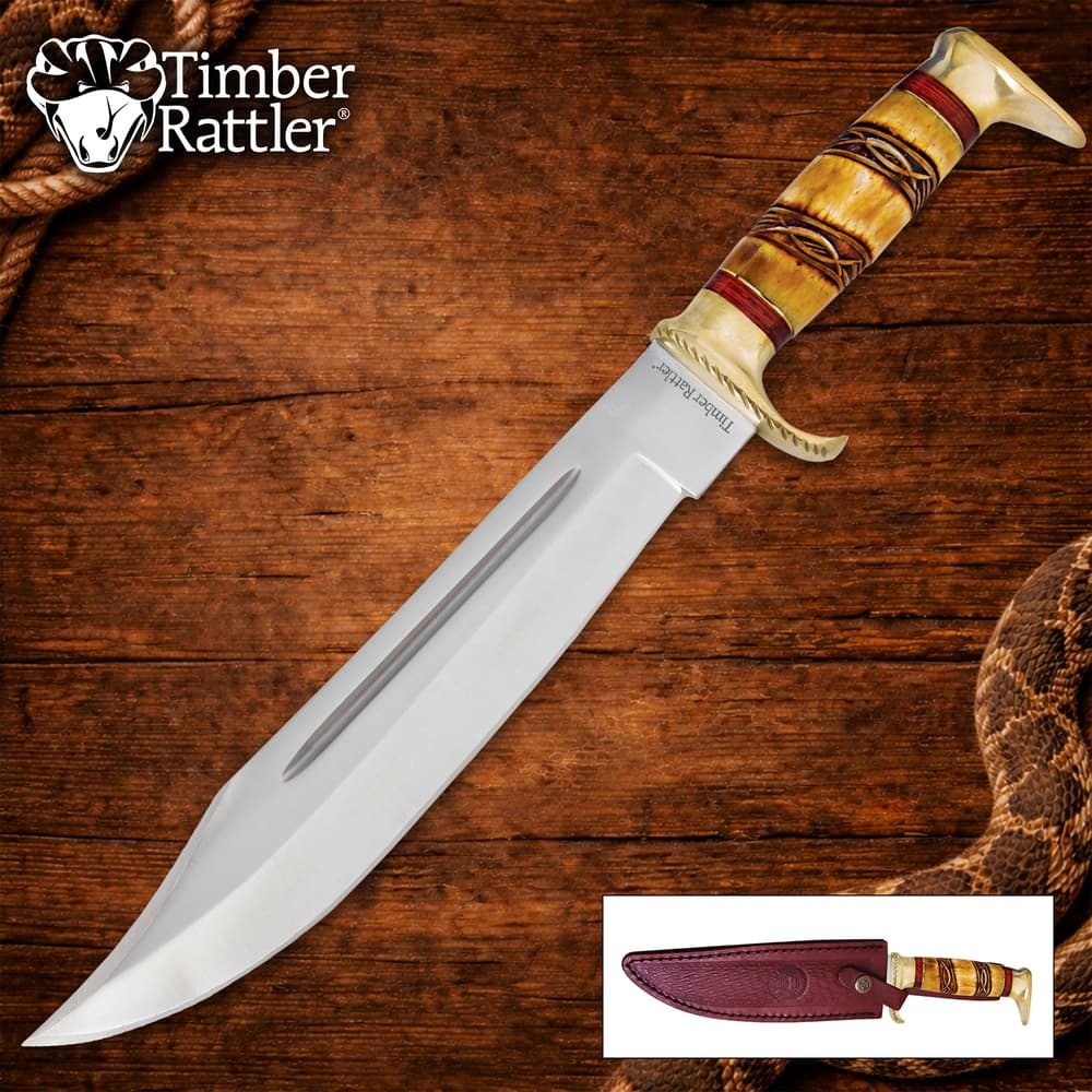 Bowie knife with a detailed handle on wooden background image number 0