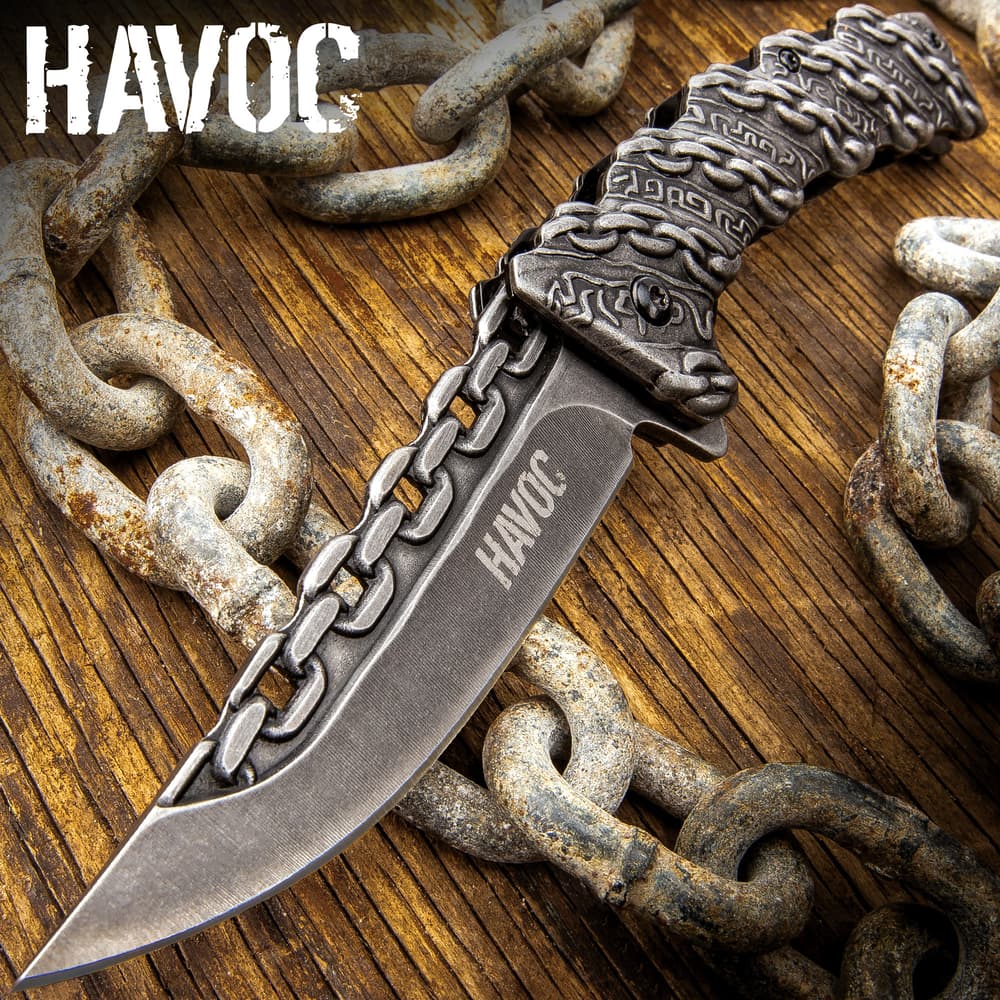 Knife with chain design on wooden surface image number 0