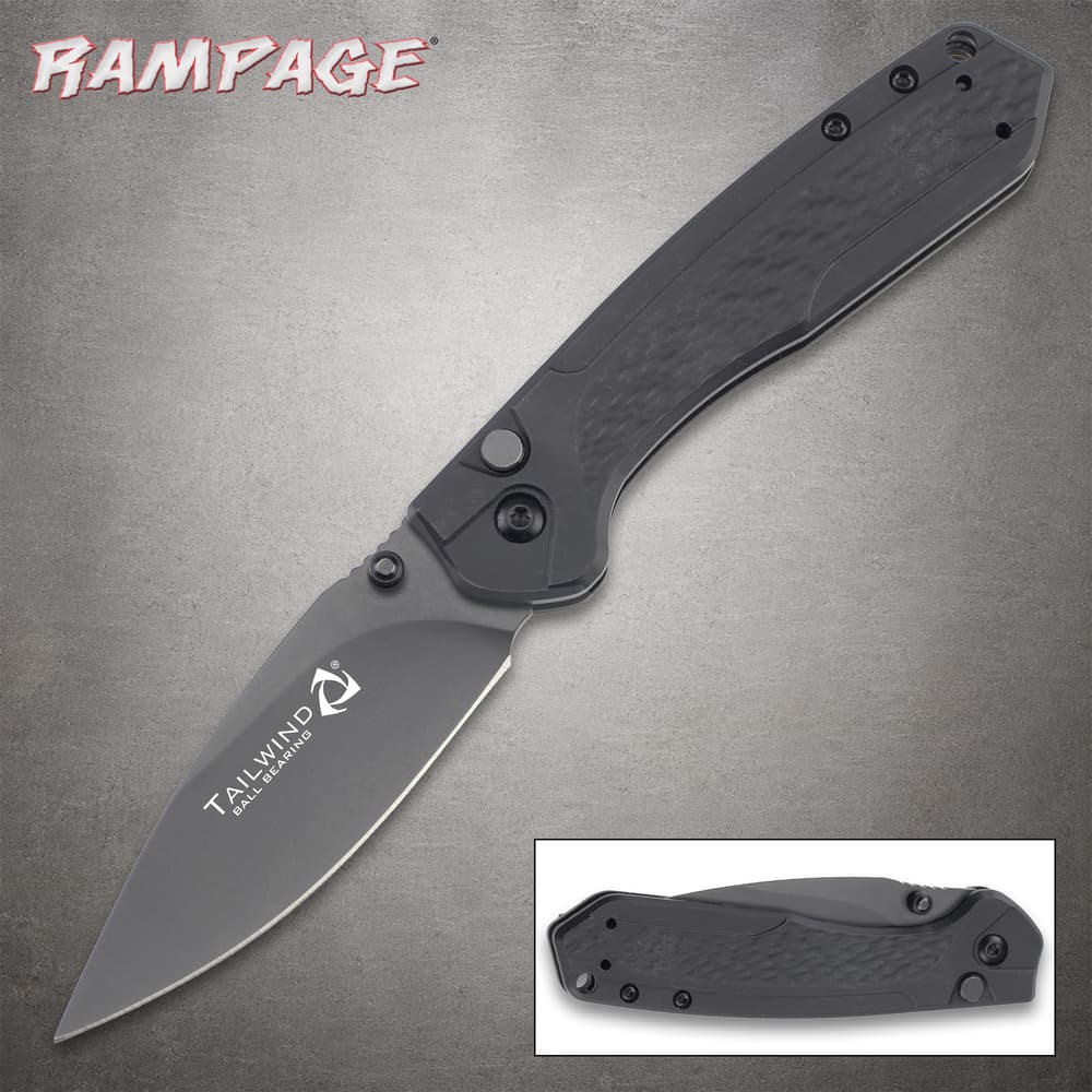 Black folding knife with textured handle and open blade image number 0