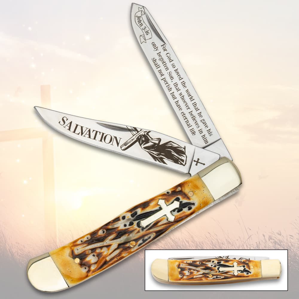 Pocket knife with Christian-themed etched blades and cross handle image number 0