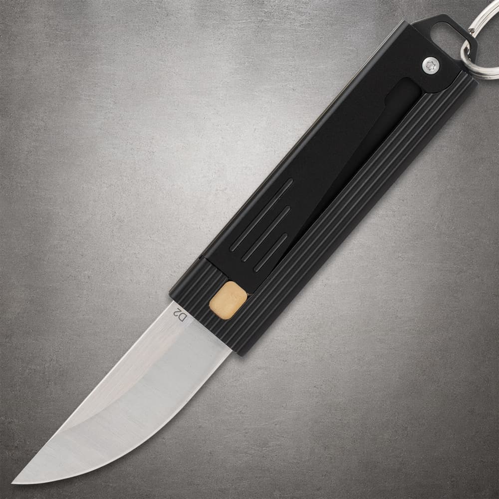 Black folding knife with a silver blade on a gray background image number 0