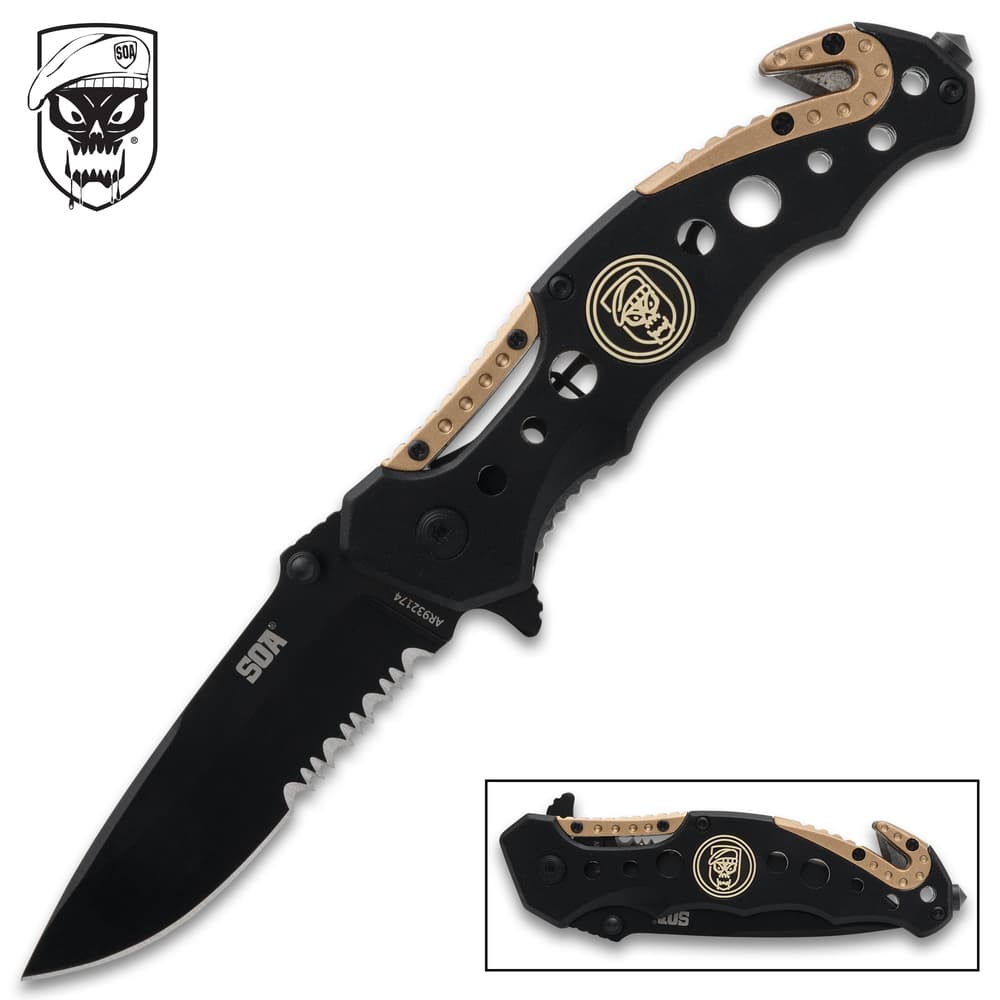 Black and tan folding knife with skull logo image number 0