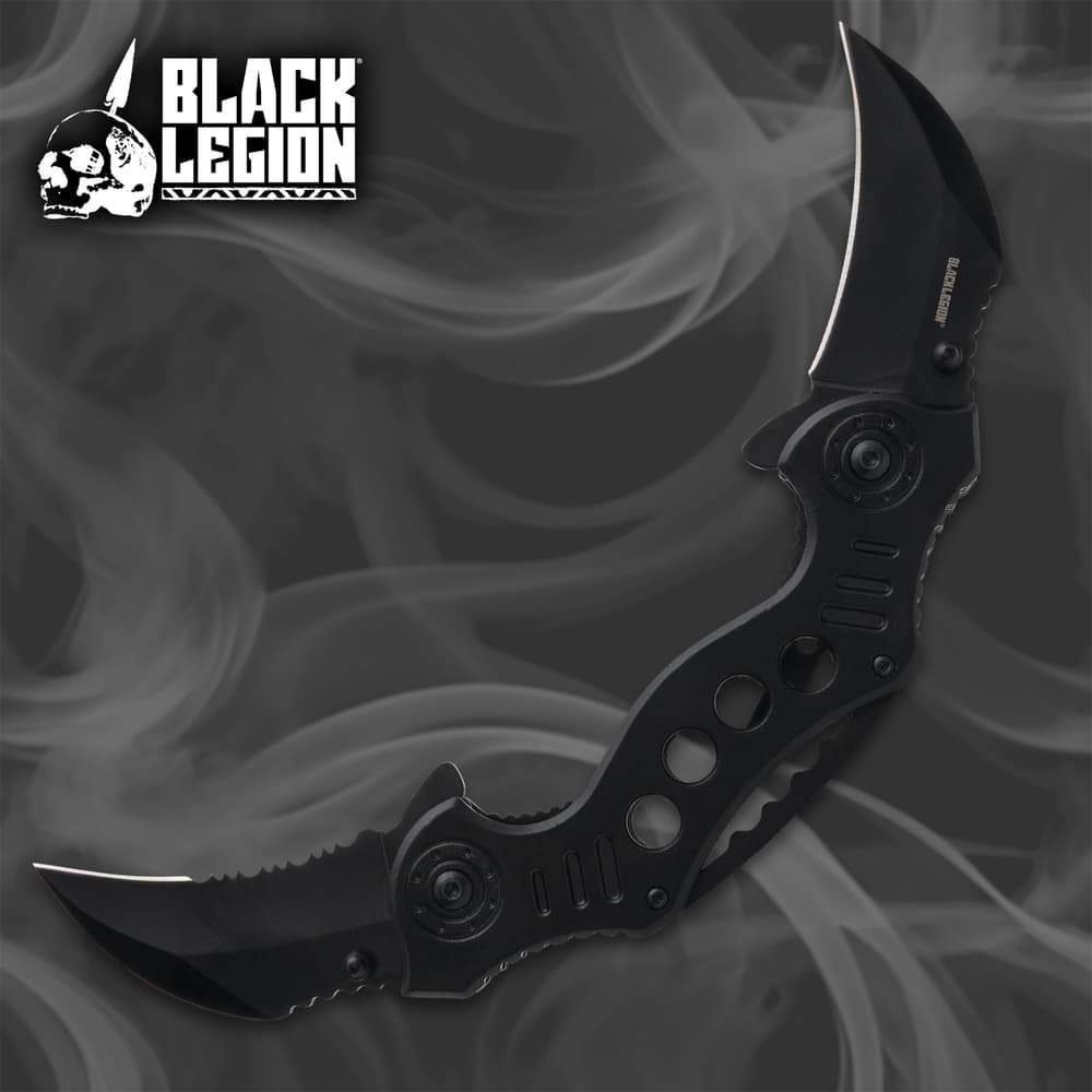 Black folding knife with dual blades on smoky background image number 0