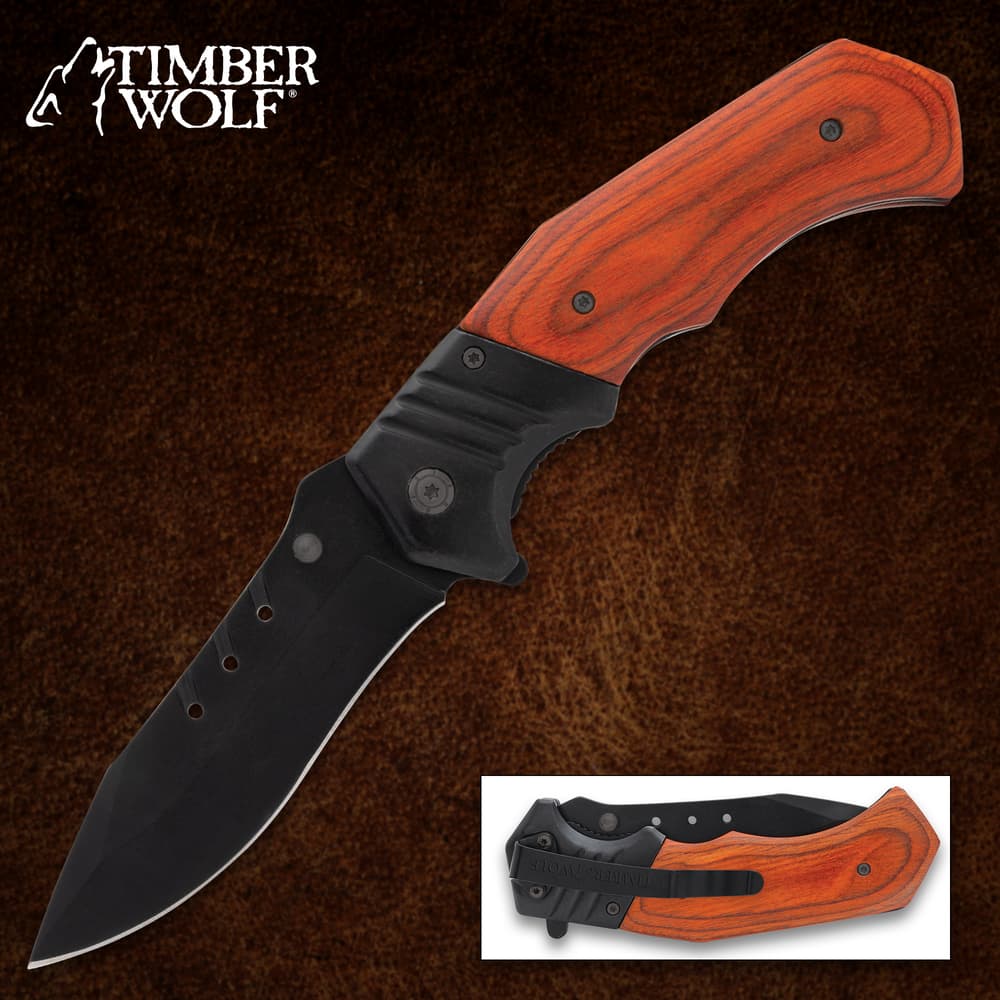 Folding knife with wooden handle on brown background image number 0