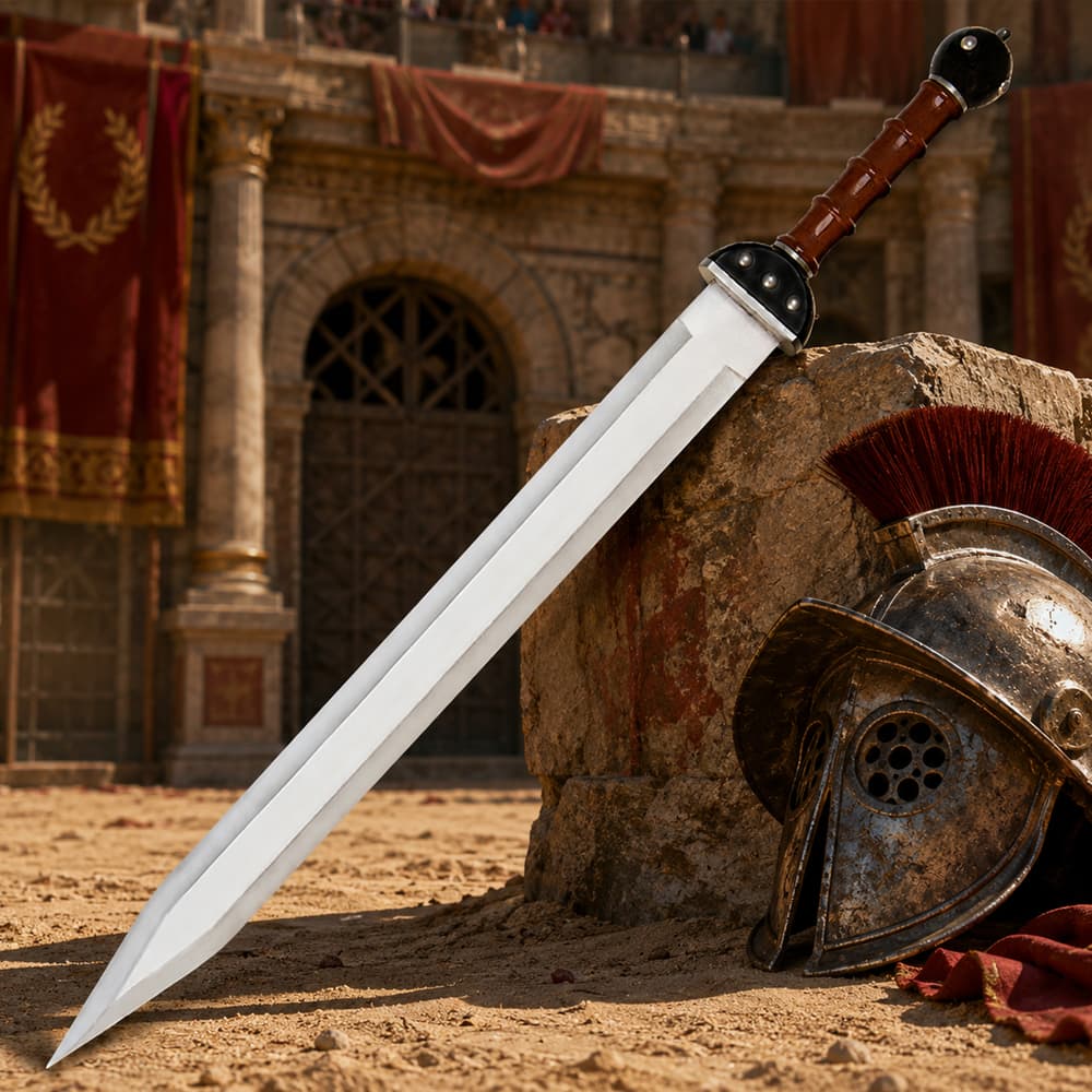 Roman sword and helmet on sandy arena floor image number 0