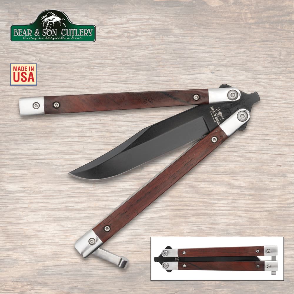 Butterfly knife with wooden handles and black blade on wood background image number 0