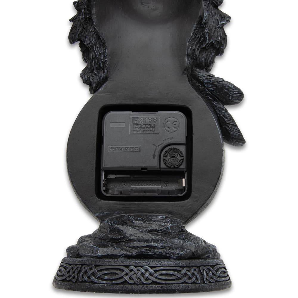 This image shows the rear of the desk clock where the battery housing and dial to change the time is located. image number 3