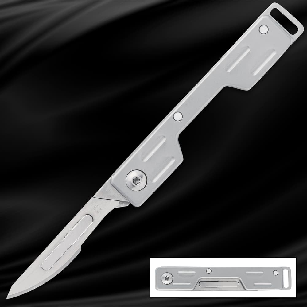 Silver folding knife with open blade on black background image number 0