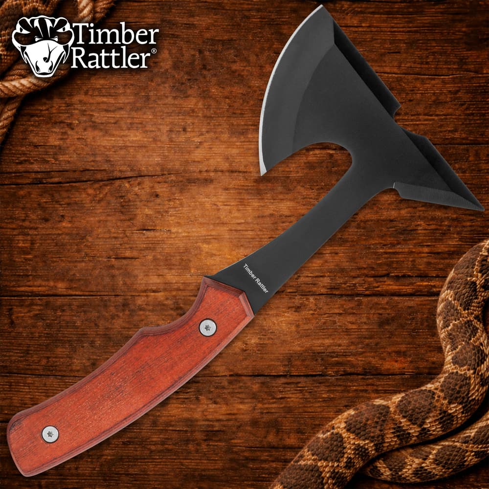 Black axe with wooden handle on wooden background image number 0