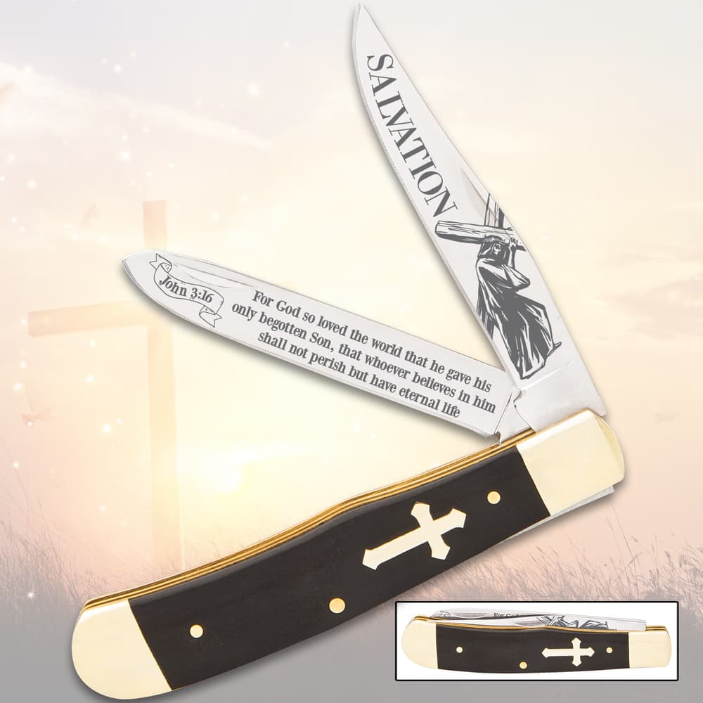 Pocket knife with Christian-themed etched blades and cross handle image number 0