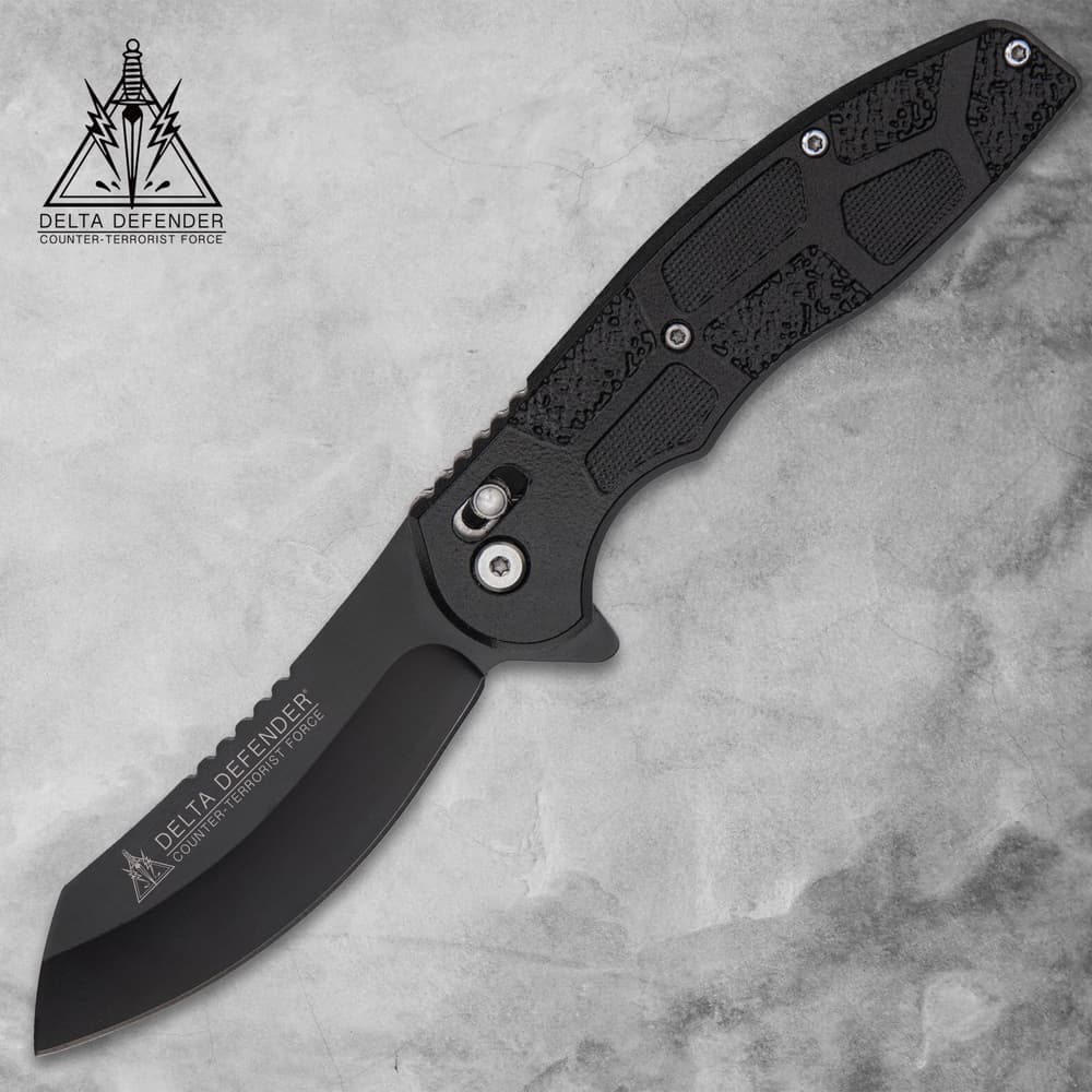 Black folding knife with textured handle on gray background image number 0
