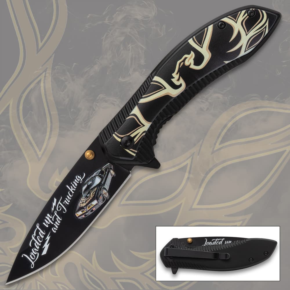 Black pocket knife with car design and text 'Loaded up and Trucking' image number 0